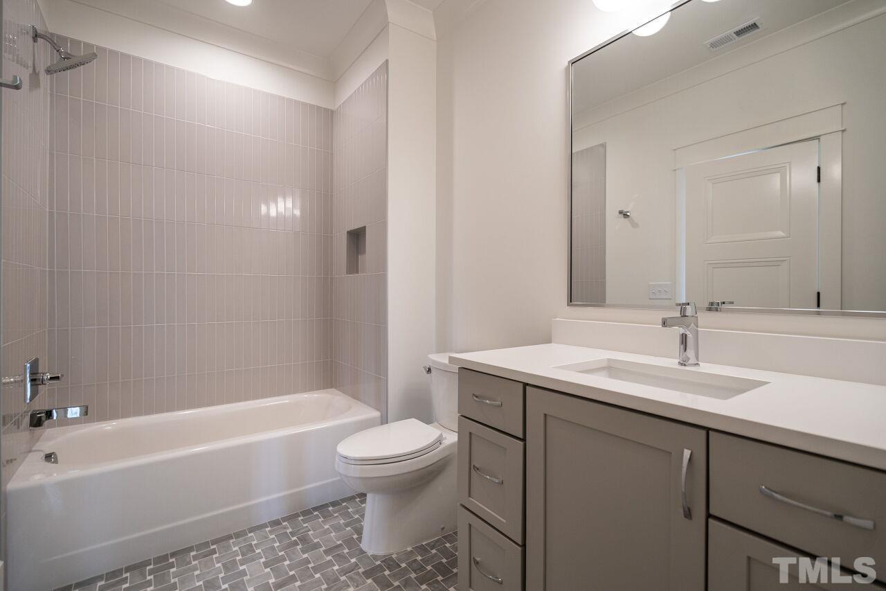 1104 Shelley Road Raleigh, NC 27609 - Photo 38 of 45 a bathroom with a sink toilet vanity and shower