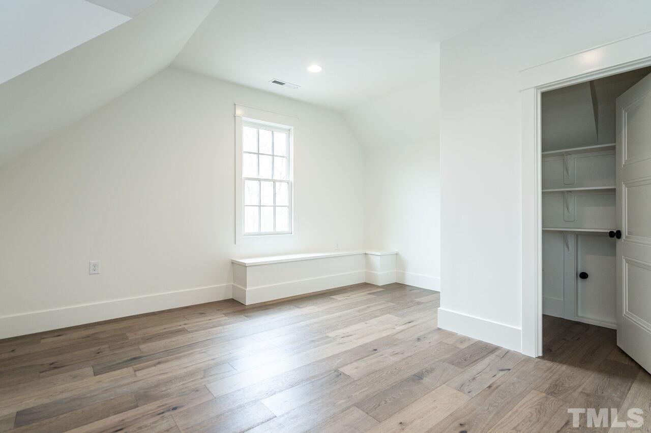 1104 Shelley Road Raleigh, NC 27609 - Photo 43 of 45 an empty room with wooden floor and windows