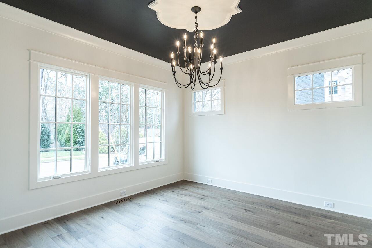 1104 Shelley Road Raleigh, NC 27609 - Photo 5 of 45 a window in an empty room with wooden floor