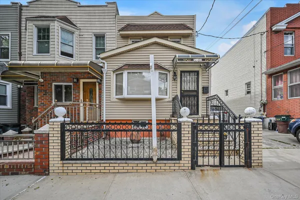 a front view of a house with iron fence