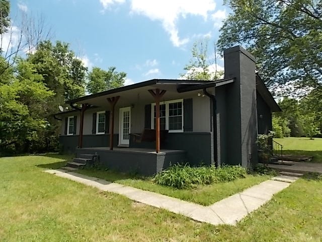 12698 Versailles Road Rockvale, TN 37153 - Photo 1 of 30 a front view of a house with a yard