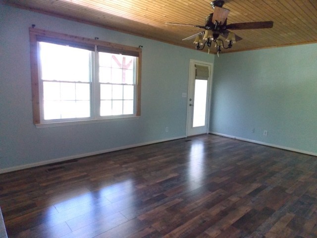12698 Versailles Road Rockvale, TN 37153 - Photo 14 of 30 a view of an empty room with wooden floor and a window