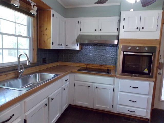 12698 Versailles Road Rockvale, TN 37153 - Photo 10 of 30 a kitchen with granite countertop white cabinets and sink