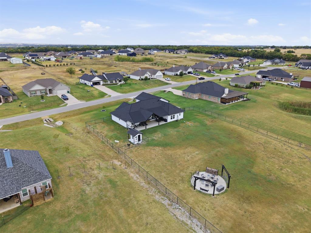 10216 Finch Road Sanger, TX 76266 - Photo 39 of 40 Expansive yard with chain link fencing and an outdoor patio