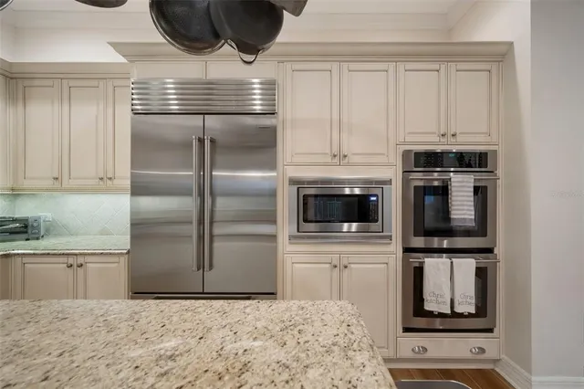 a bedroom with a bed a lamp and wooden floor