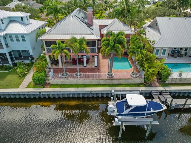 a view of a house with backyard and sitting area