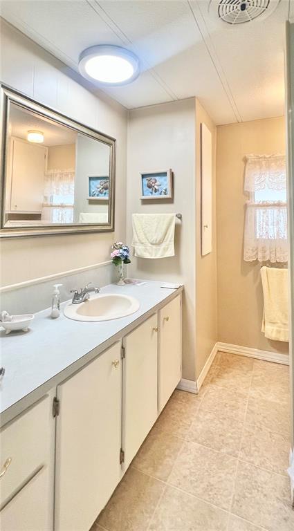 1100 South Belcher Road, Unit 197 Largo, FL 33771 - Photo 12 of 60 a bathroom with a granite countertop sink mirror and next to a window