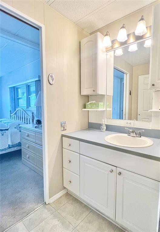 1100 South Belcher Road, Unit 197 Largo, FL 33771 - Photo 14 of 60 a bathroom with a sink vanity granite tub and a mirror