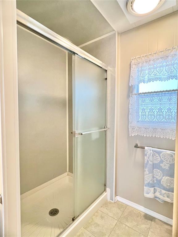 1100 South Belcher Road, Unit 197 Largo, FL 33771 - Photo 16 of 60 a bathroom with a glass shower door