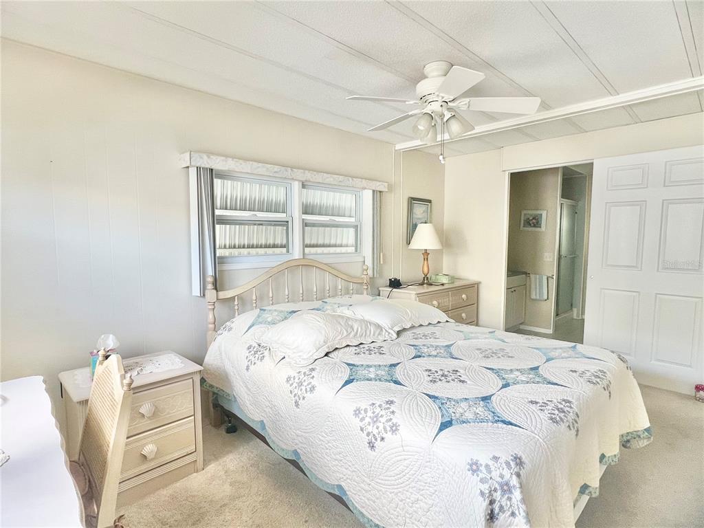 1100 South Belcher Road, Unit 197 Largo, FL 33771 - Photo 17 of 60 a bedroom with a bed and a chandelier