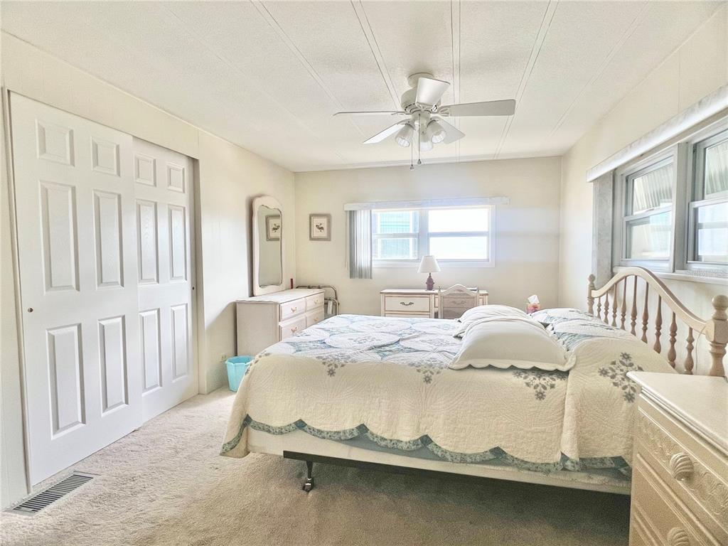 1100 South Belcher Road, Unit 197 Largo, FL 33771 - Photo 18 of 60 a bed room with a bed and a chandelier