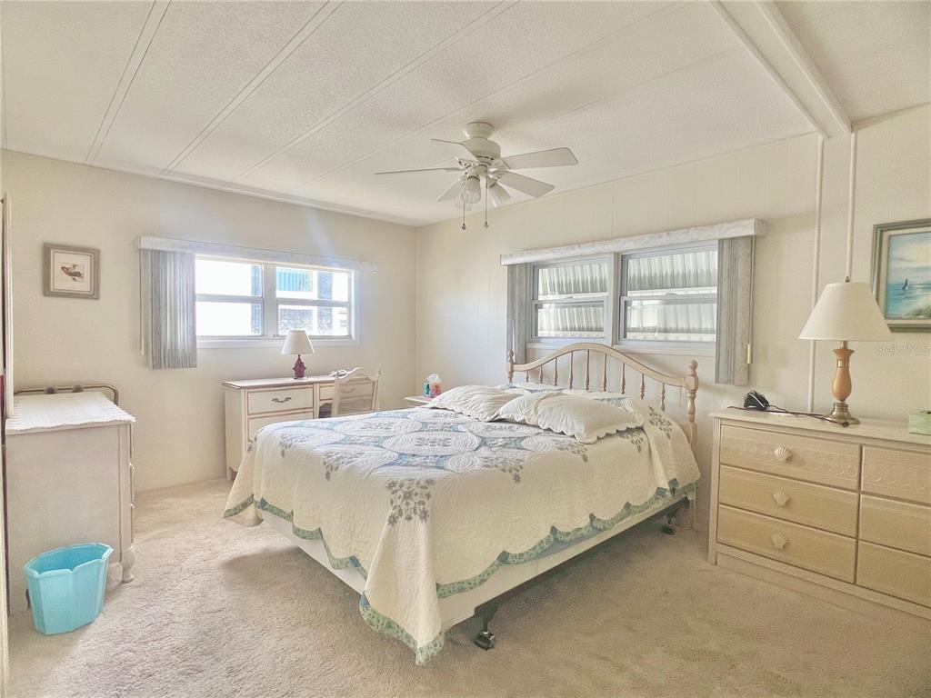 1100 South Belcher Road, Unit 197 Largo, FL 33771 - Photo 19 of 60 a spacious bedroom with a bed and a dresser next to a window