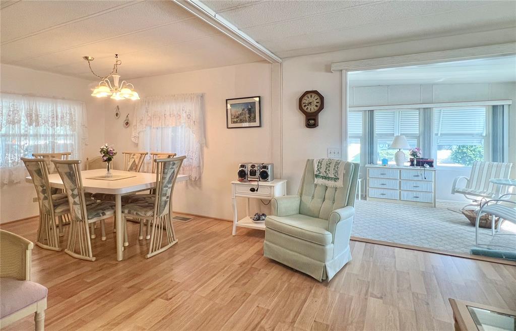 1100 South Belcher Road, Unit 197 Largo, FL 33771 - Photo 4 of 60 a view of a dining room with furniture and wooden floor
