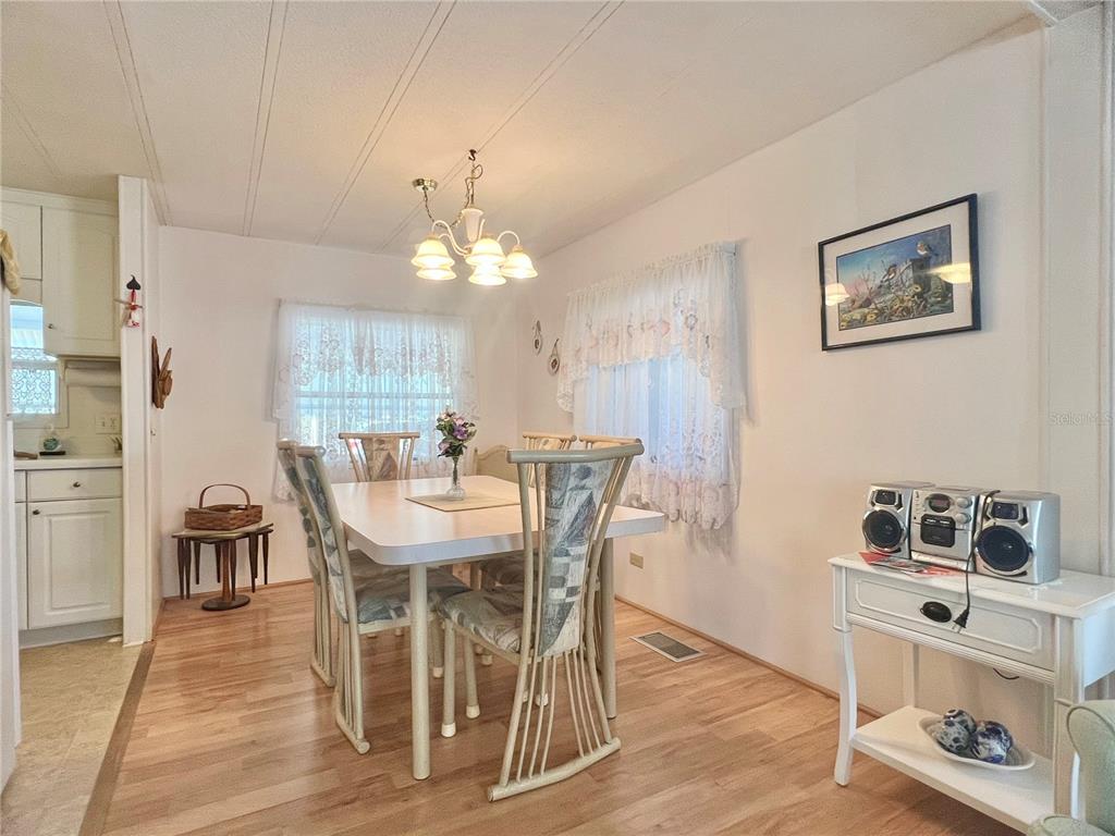 1100 South Belcher Road, Unit 197 Largo, FL 33771 - Photo 5 of 60 a view of a dining room with furniture and chandelier