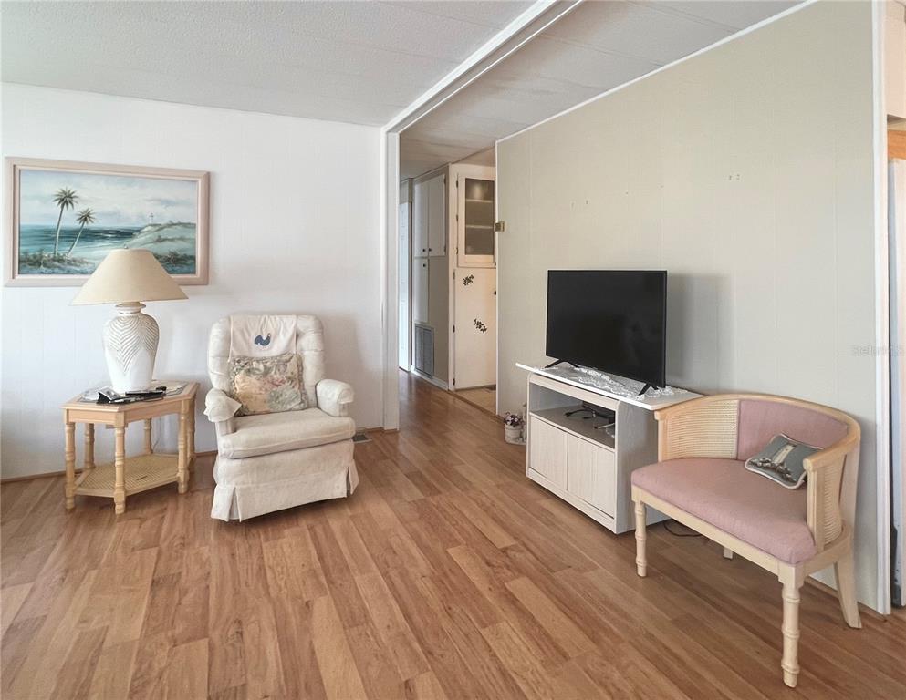 1100 South Belcher Road, Unit 197 Largo, FL 33771 - Photo 6 of 60 a living room with furniture and a flat screen tv