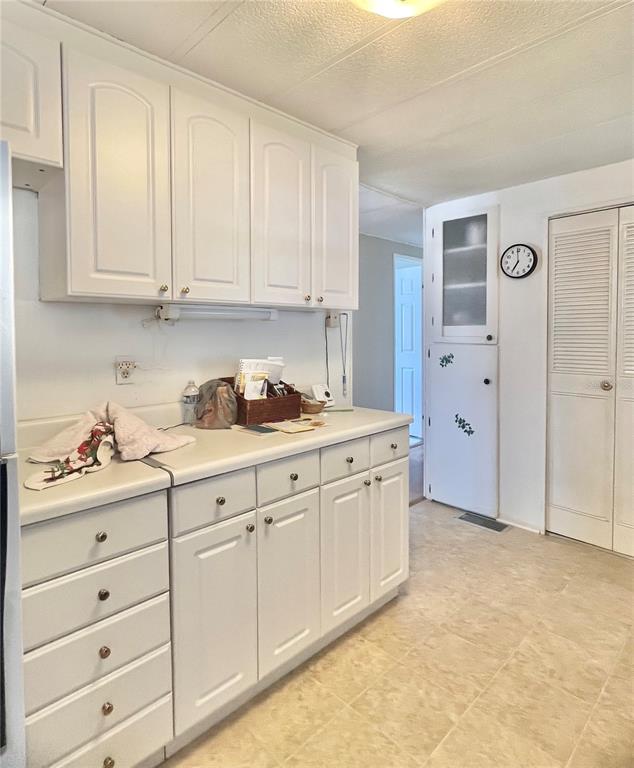 1100 South Belcher Road, Unit 197 Largo, FL 33771 - Photo 8 of 60 a kitchen with granite countertop white cabinets and sink