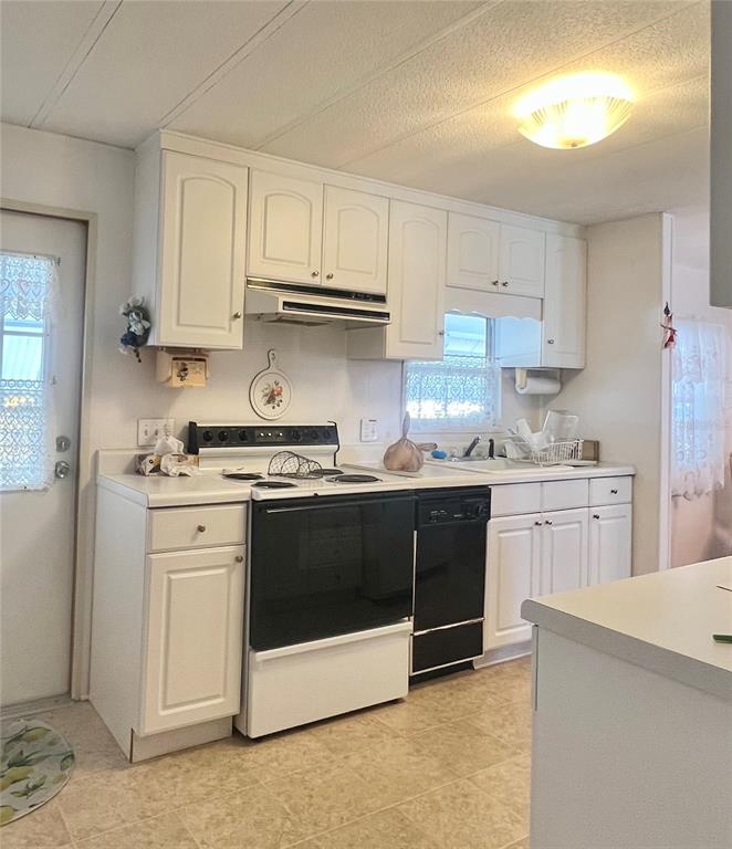 1100 South Belcher Road, Unit 197 Largo, FL 33771 - Photo 10 of 60 a kitchen with stainless steel appliances granite countertop a stove a sink and a refrigerator
