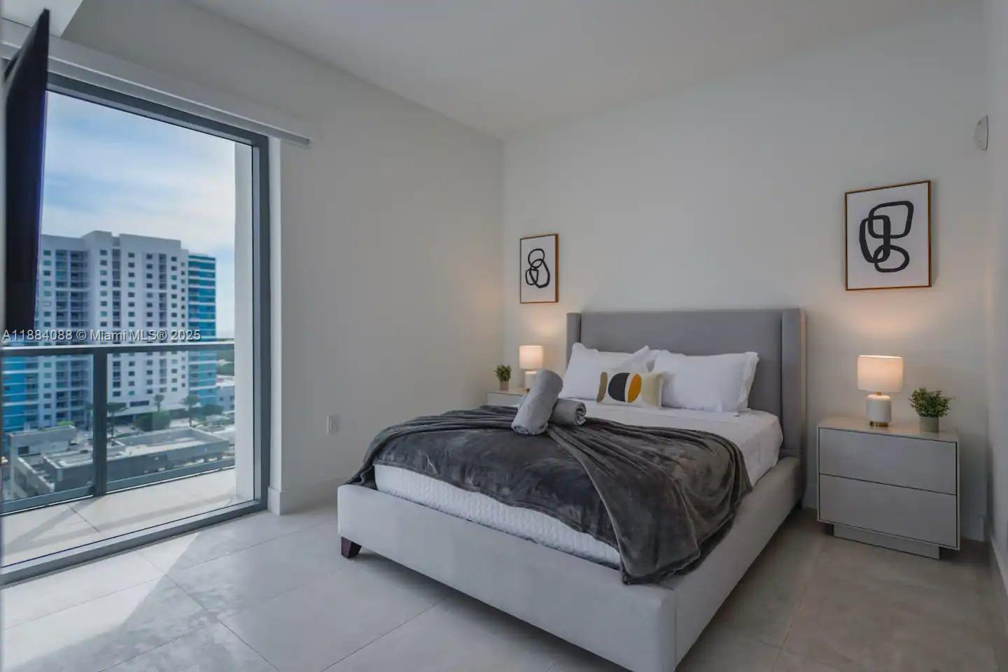 239 Southwest 9th Street, Unit 1601 Miami, FL 33130 - Photo 11 of 23 a bedroom with a bed and a large window