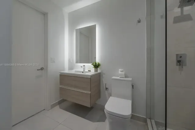 a bathroom with a sink a toilet and mirror
