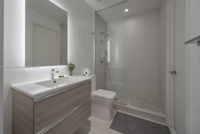 a bathroom with a sink toilet and shower