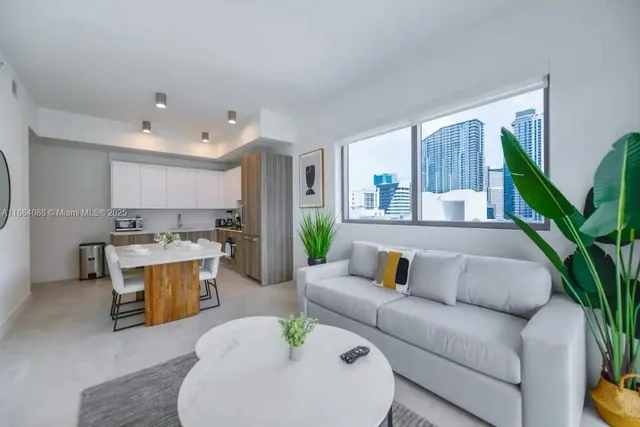 a living room with furniture and a potted plant