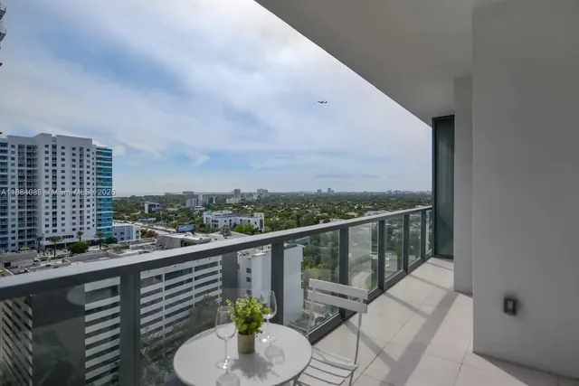 a view of a balcony with wooden floor and iron fence