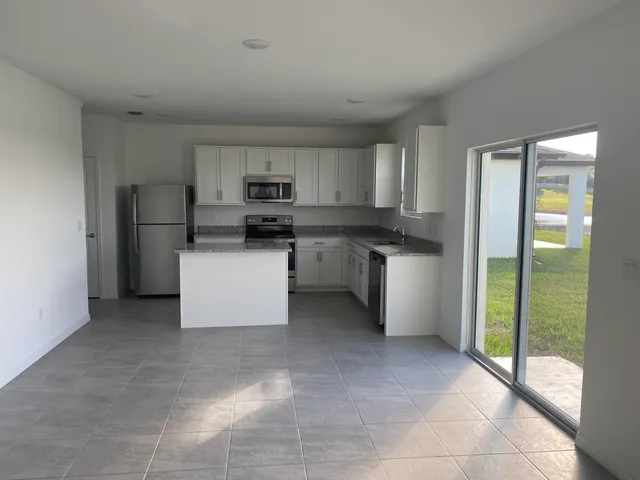 a kitchen with a sink a counter top space and appliances