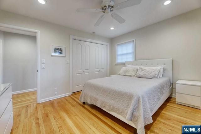 230 Pinelynn Road Glen Rock, NJ 07452 - Photo 12 of 19 a bedroom with a bed and a chandelier