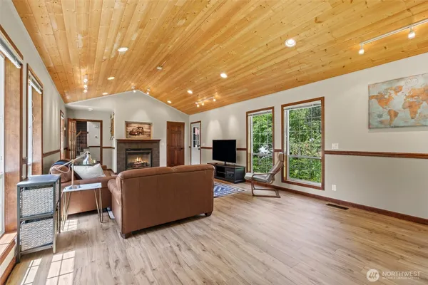 a living room with furniture wooden floor and a large window