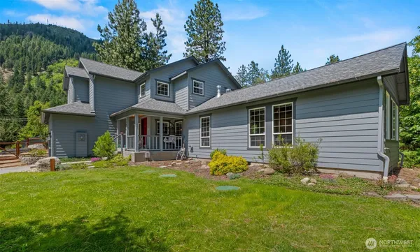 a front view of a house with a yard and porch