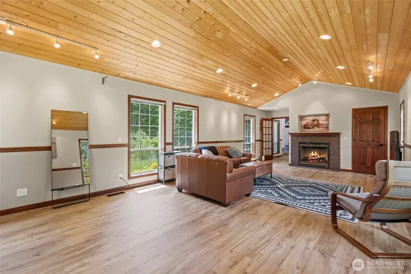 a living room with furniture wooden floor and a fireplace
