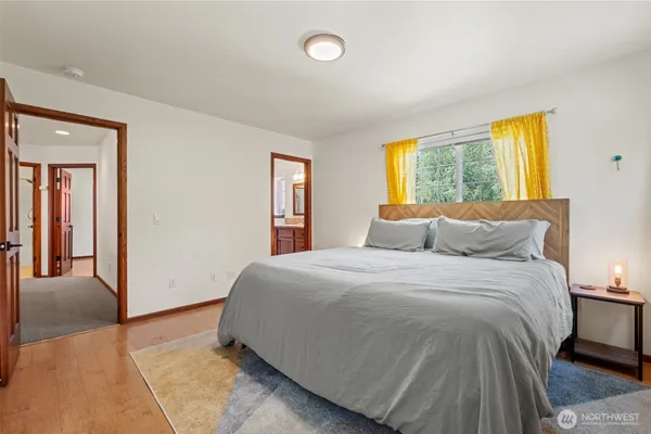 a bed sitting in a bedroom next to a window