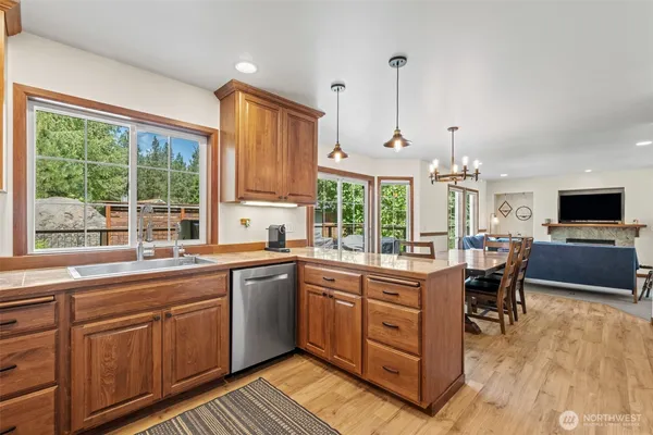 a kitchen with a sink stove and wooden cabinets