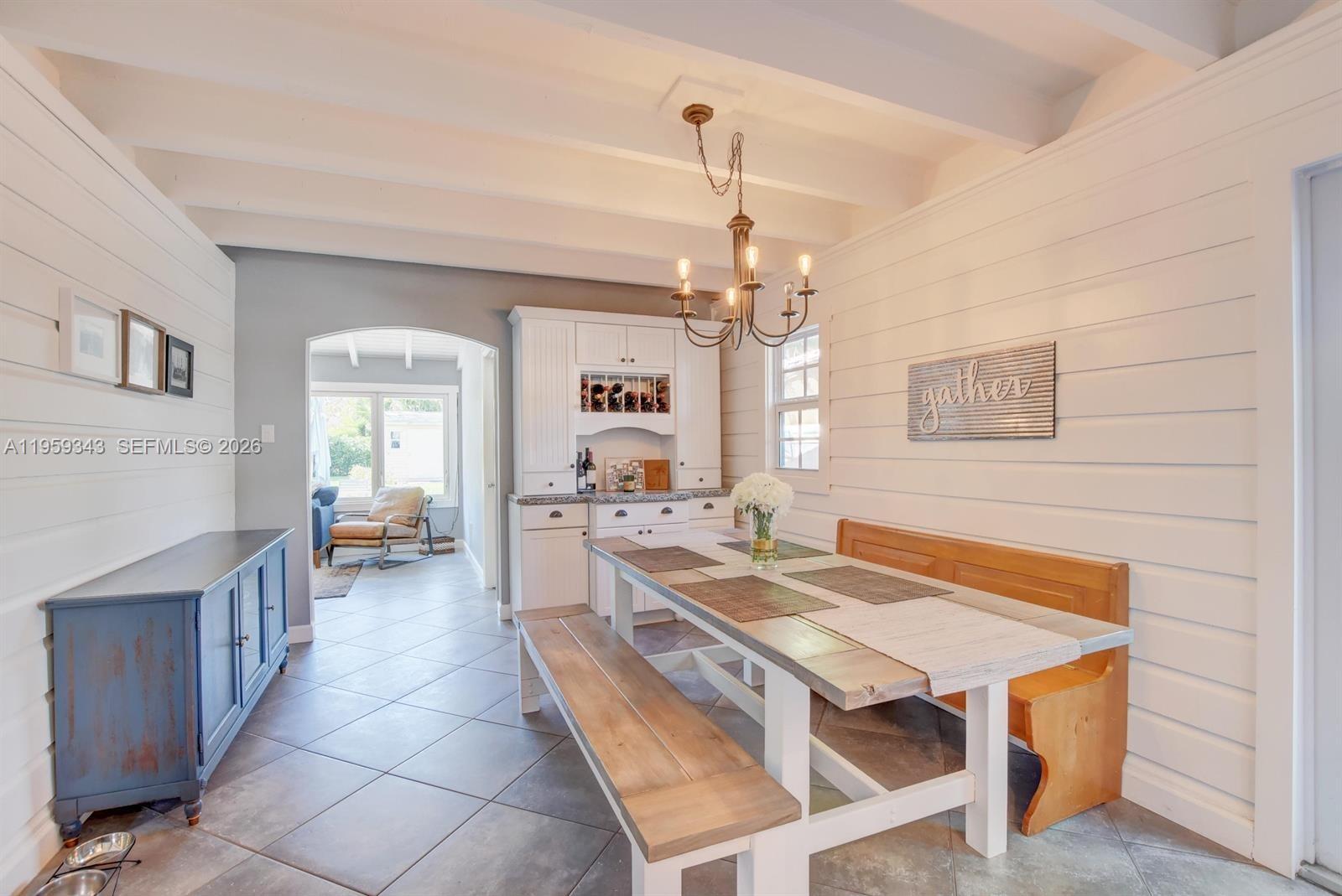 1210 Southwest 19th Street Boca Raton, FL 33486 - Photo 17 of 43 a view of a dining room and livingroom with furniture wooden floor a chandelier