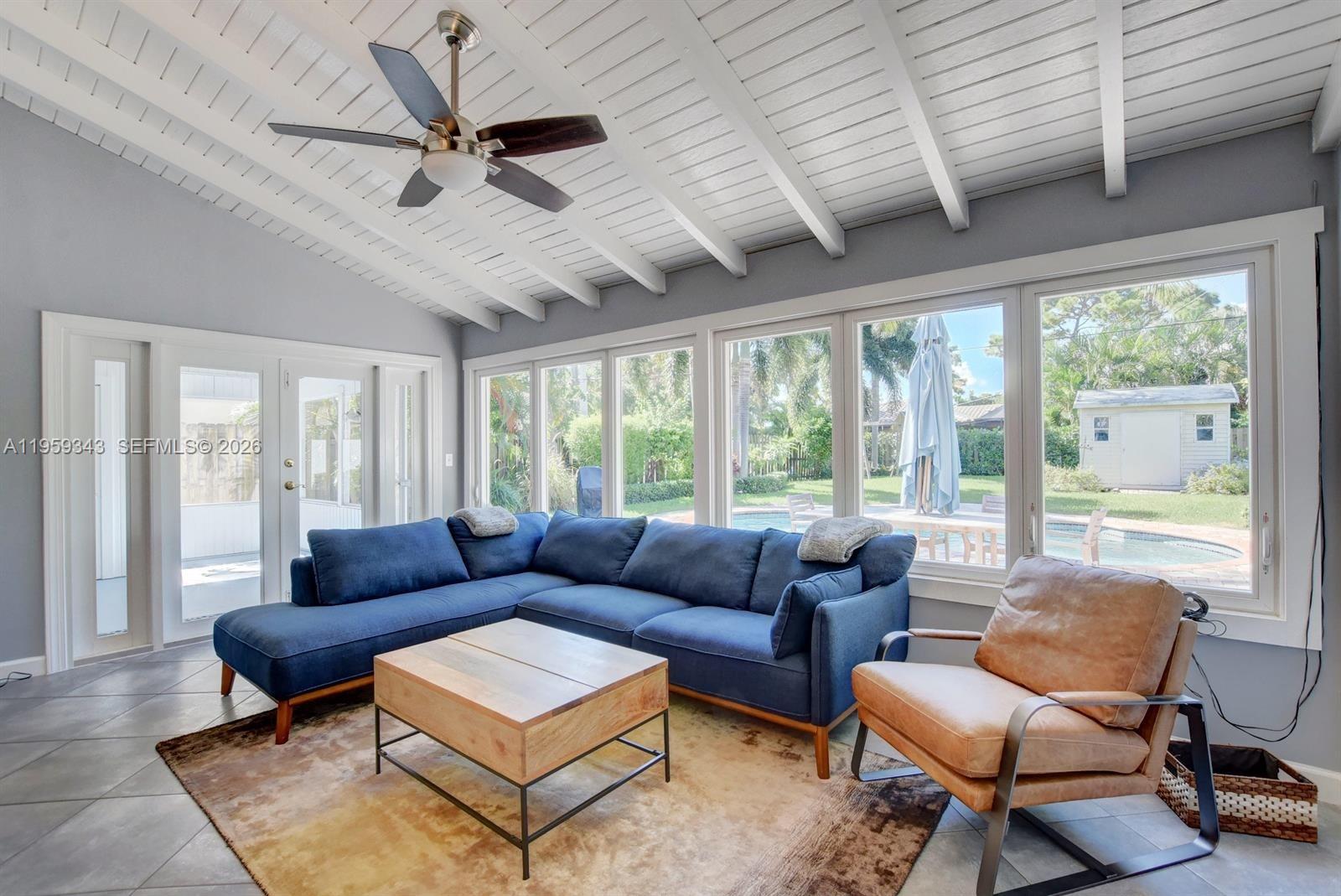 1210 Southwest 19th Street Boca Raton, FL 33486 - Photo 20 of 43 a living room with furniture a ceiling fan and a large window