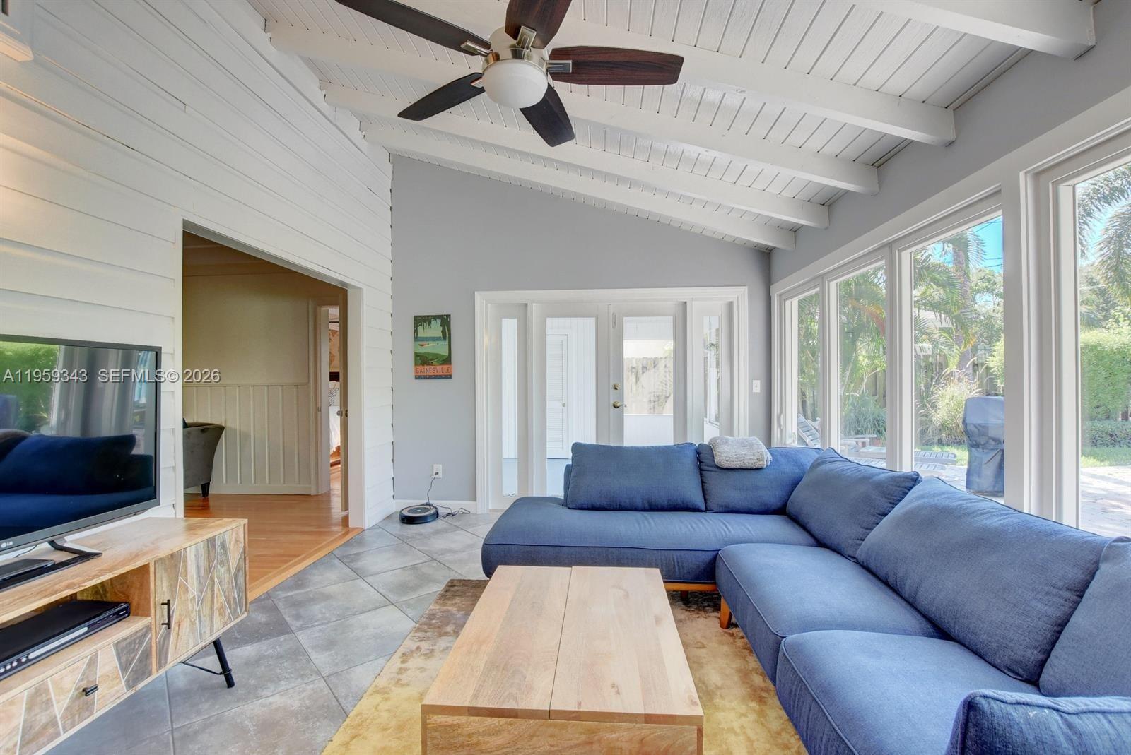 1210 Southwest 19th Street Boca Raton, FL 33486 - Photo 21 of 43 a living room with furniture and a flat screen tv