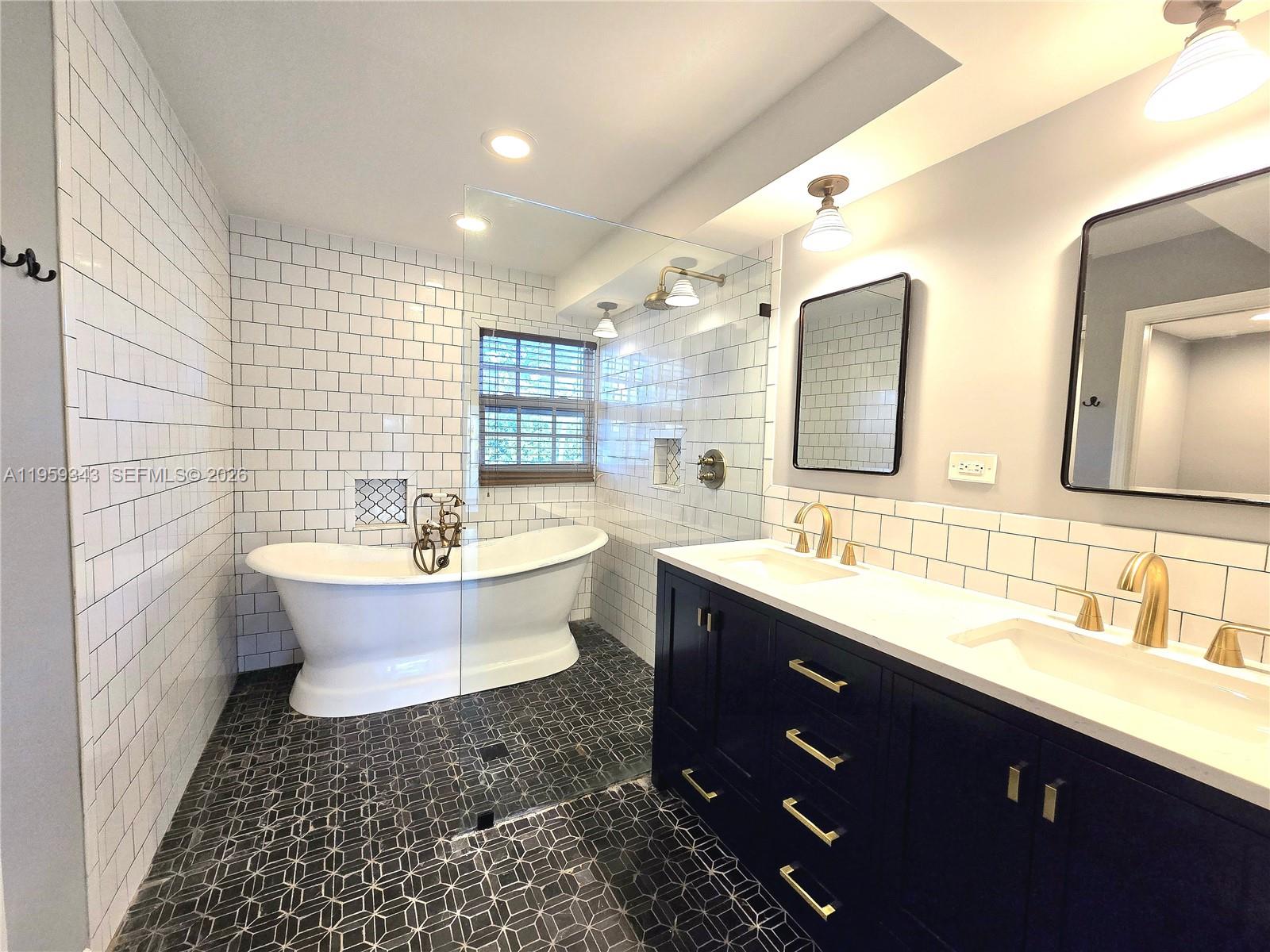 1210 Southwest 19th Street Boca Raton, FL 33486 - Photo 25 of 43 a bathroom with a double vanity sink mirror and bathtub