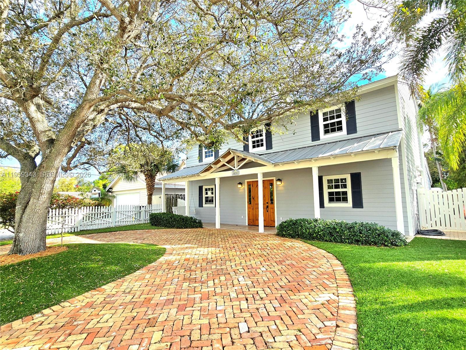 1210 Southwest 19th Street Boca Raton, FL 33486 - Photo 3 of 43 front view of a house with a yard