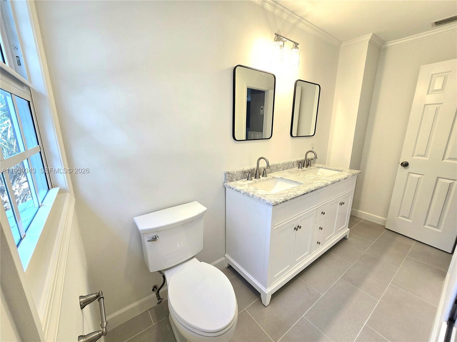 1210 Southwest 19th Street Boca Raton, FL 33486 - Photo 33 of 43 a bathroom with a granite countertop toilet sink and mirror