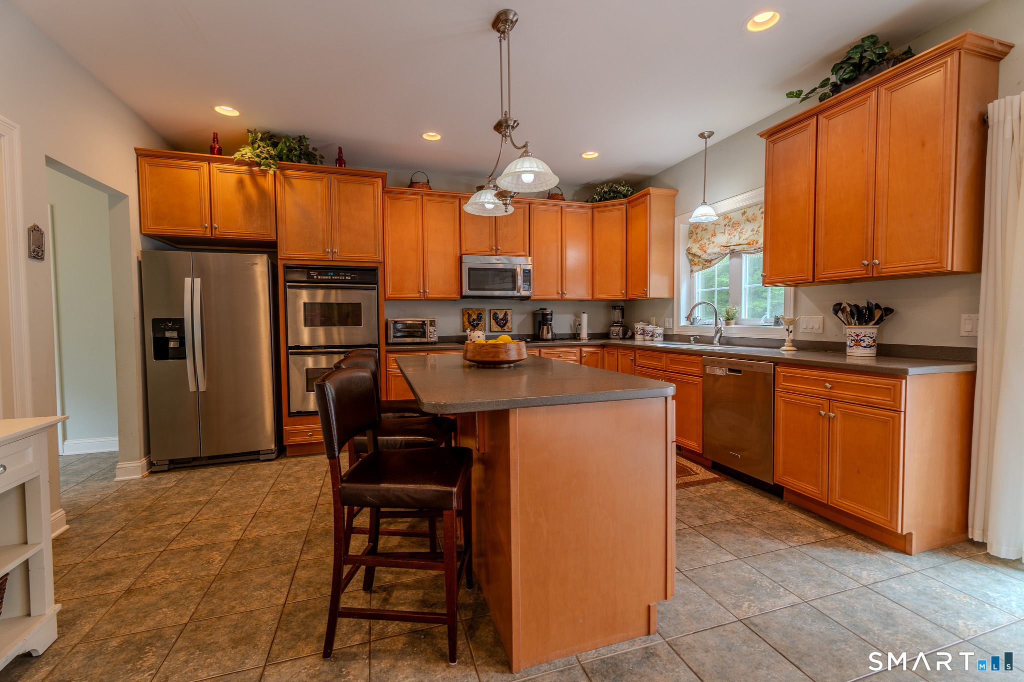 4 Ortense Road Wallingford, CT 06492 - Photo 10 of 33 a kitchen with stainless steel appliances kitchen island granite countertop a refrigerator a sink a stove and oven