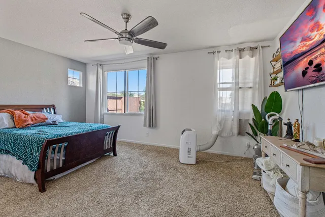 a bedroom with a bed and a potted plant