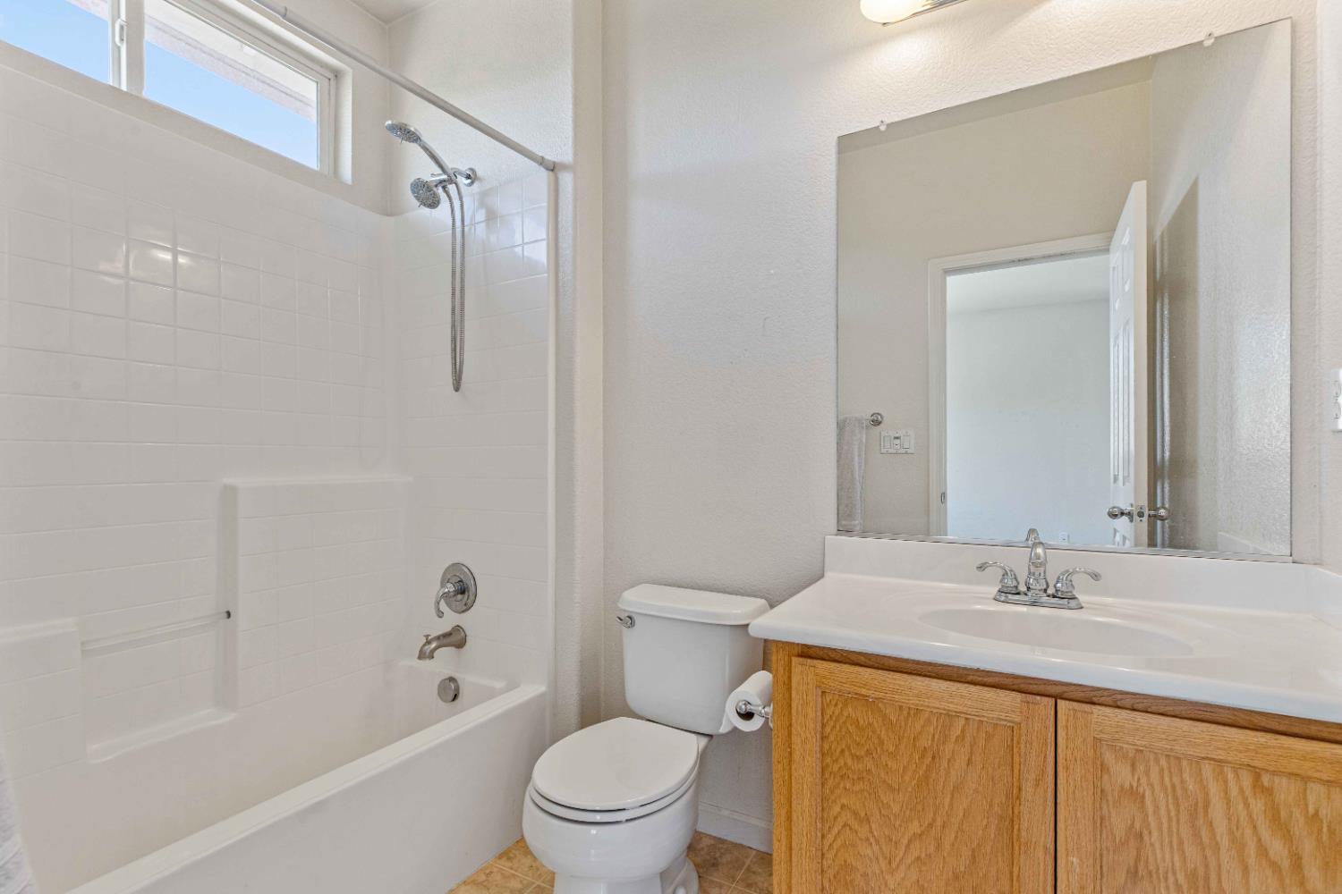 9015 Tee Patterson, CA 95363 - Photo 19 of 36 a bathroom with a granite countertop sink a toilet and shower