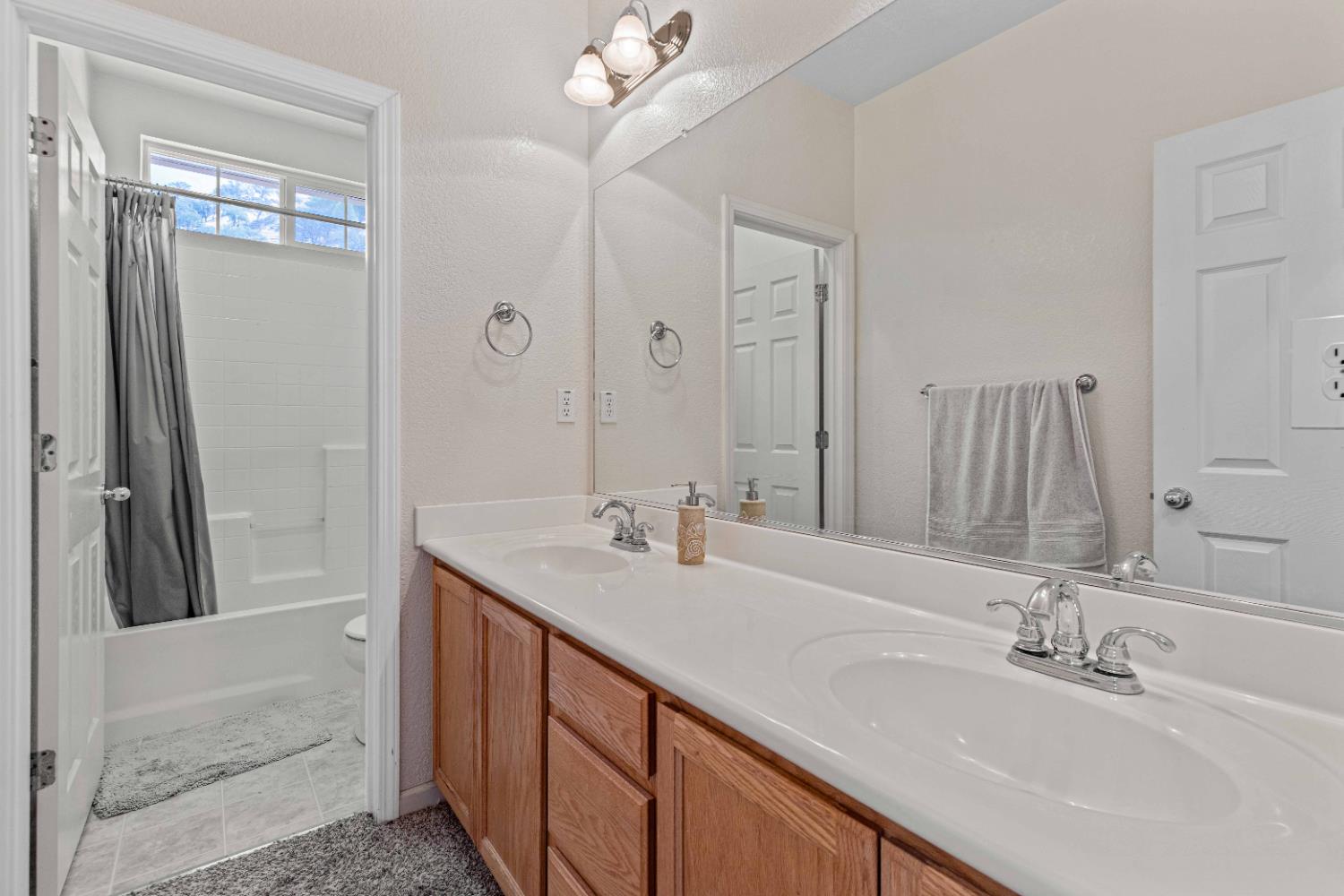 9015 Tee Patterson, CA 95363 - Photo 23 of 36 a bathroom with double vanity sinks and a mirror