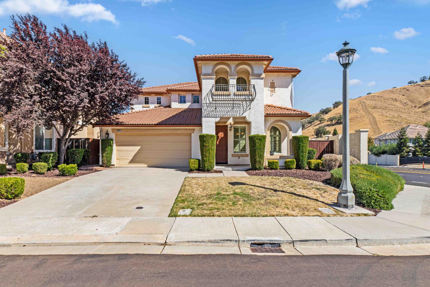 9015 Tee Patterson, CA 95363 - Photo 3 of 36 a front view of a building with a garden and plants