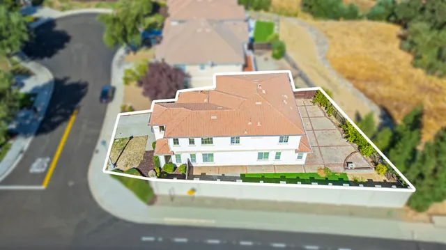 an aerial view of a house with a swimming pool
