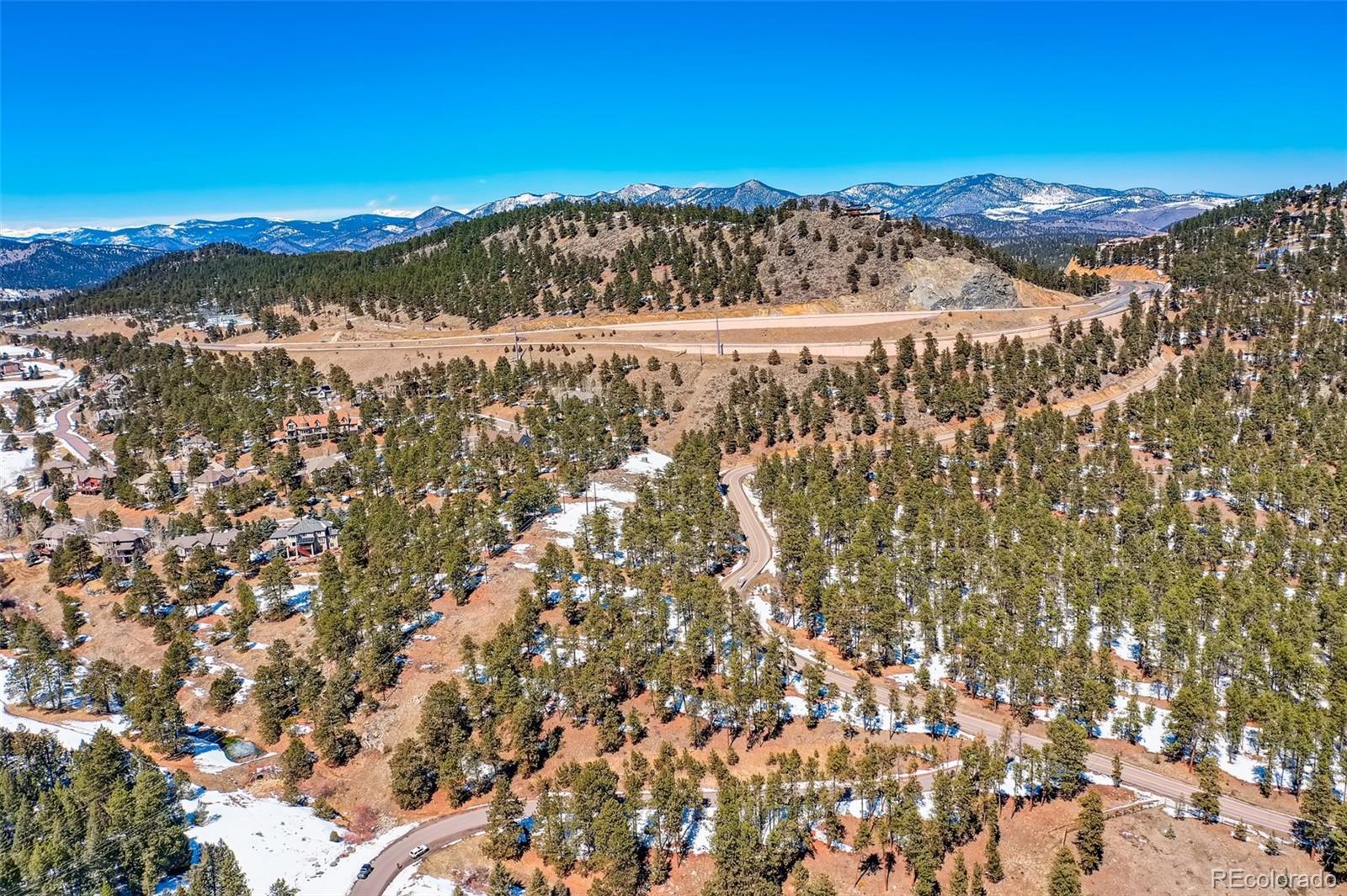 1493 Pinedale Ranch Circle Evergreen, CO 80439 - Photo 12 of 19 a view of a city with mountains in the background