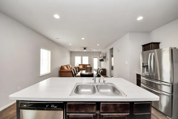 a large kitchen with a table and chairs