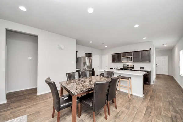 a view of a dining room with furniture and wooden floor