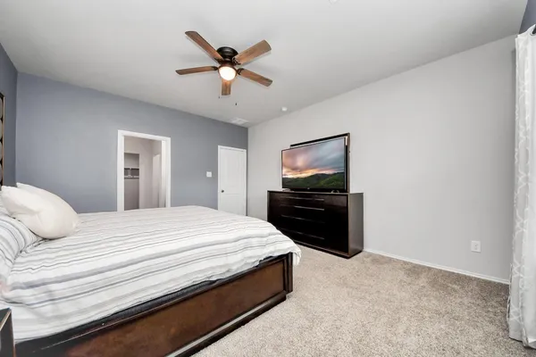 a bedroom with a bed and a chandelier