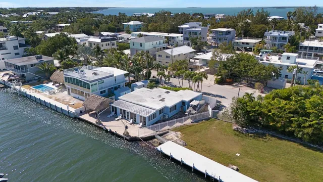 a living room with furniture and large windows